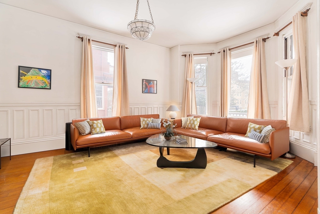 61 Centre Street Brookline, MA 02446 - Photo 11 of 31 a living room with furniture and a large window