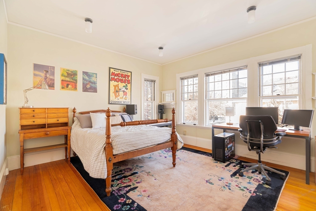 61 Centre Street Brookline, MA 02446 - Photo 18 of 31 a bedroom with a bed and wooden floor