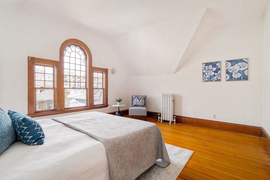 61 Centre Street Brookline, MA 02446 - Photo 19 of 31 a bedroom with a bed and a painting on the wall