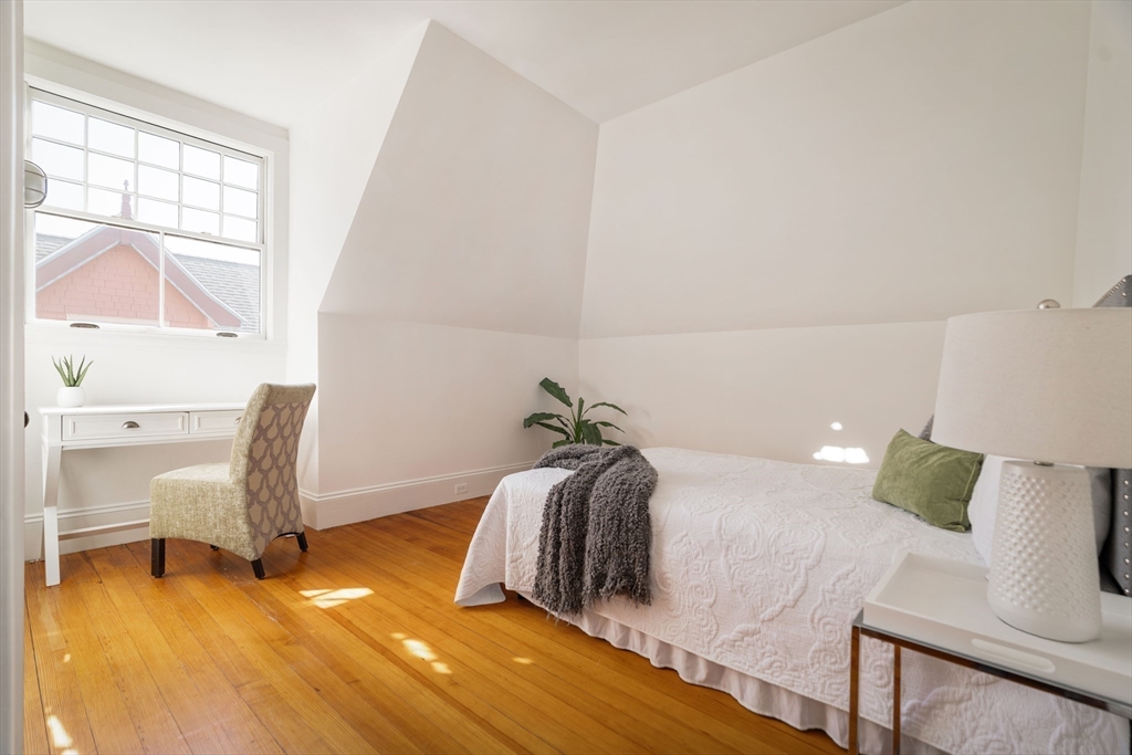 61 Centre Street Brookline, MA 02446 - Photo 20 of 31 a bedroom with a bed and a chair