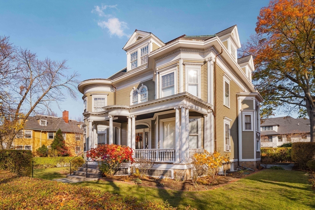 61 Centre Street Brookline, MA 02446 - Photo 2 of 31 a front view of a house with swimming pool and glass windows