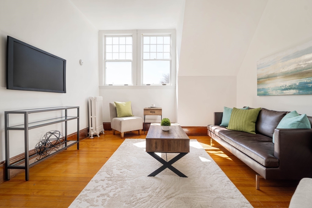 61 Centre Street Brookline, MA 02446 - Photo 22 of 31 a living room with furniture and a flat screen tv
