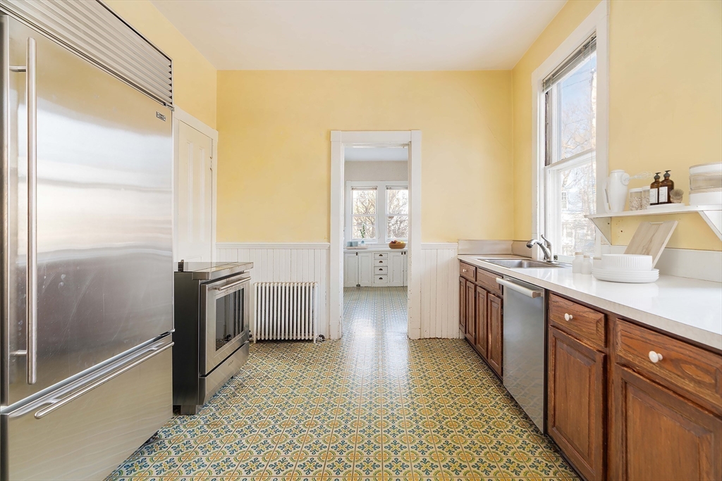 61 Centre Street Brookline, MA 02446 - Photo 24 of 31 a bathroom with a sink a toilet and shower