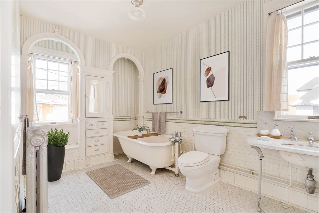 61 Centre Street Brookline, MA 02446 - Photo 26 of 31 a bathroom with a double vanity sink mirror and toilet