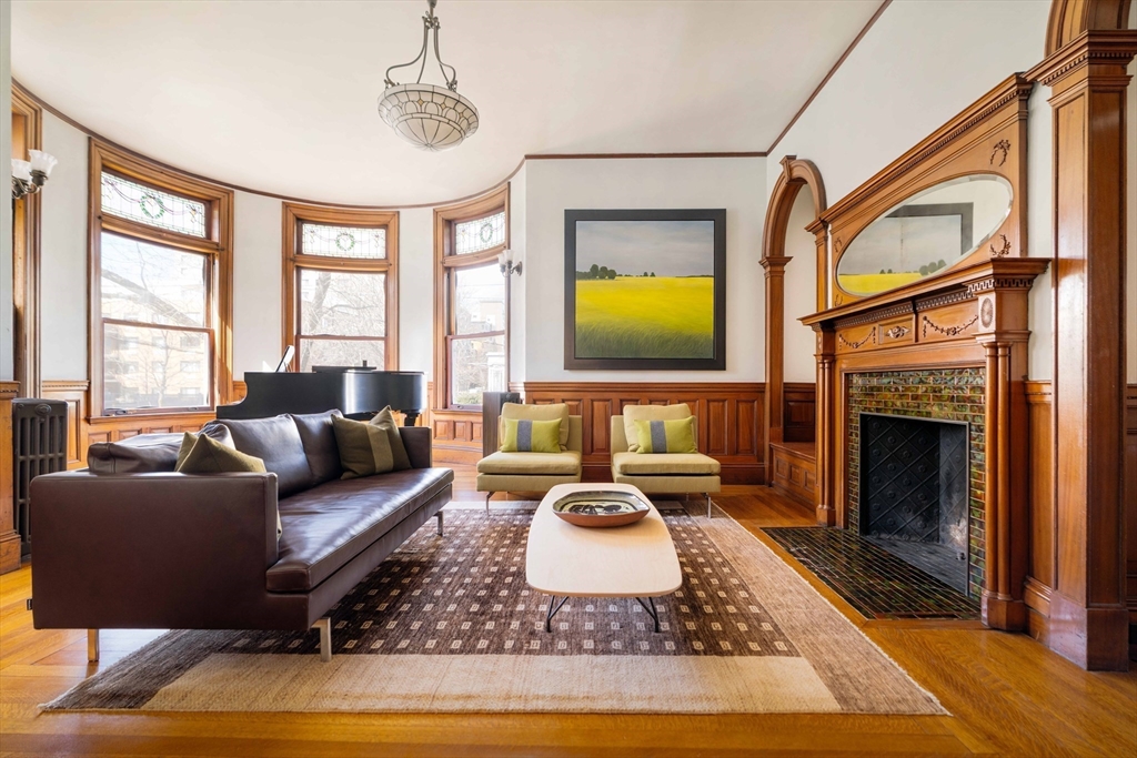 61 Centre Street Brookline, MA 02446 - Photo 3 of 31 a living room with furniture a window and a fireplace