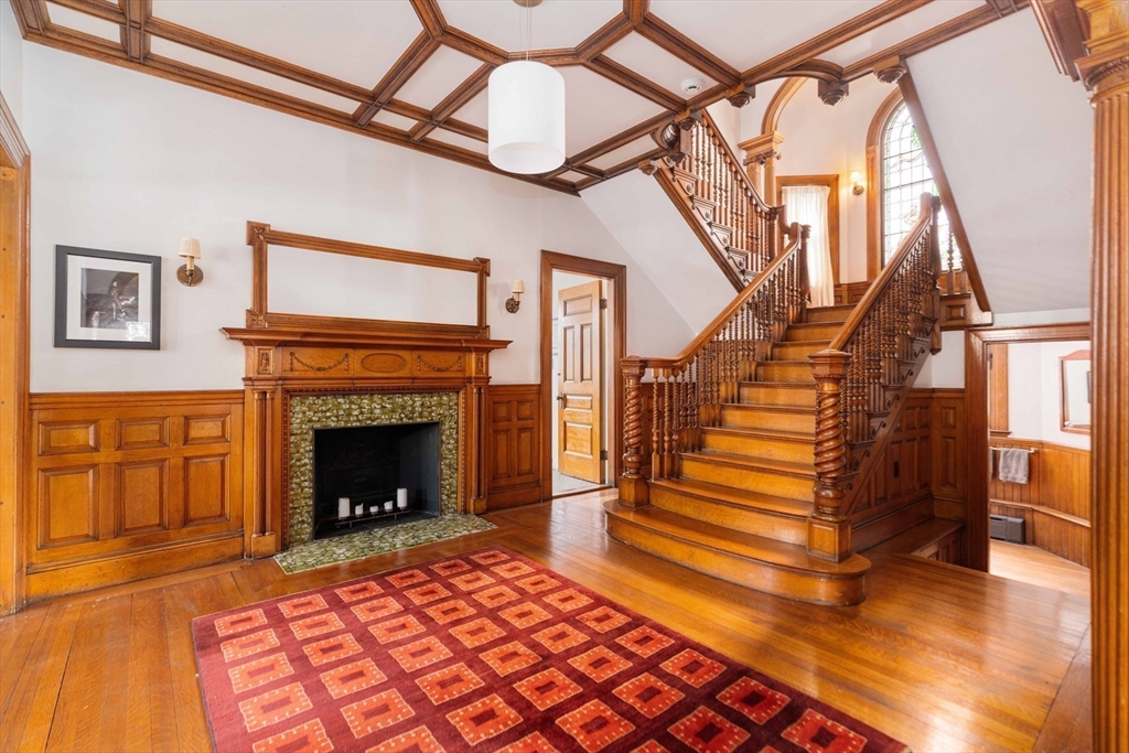 61 Centre Street Brookline, MA 02446 - Photo 10 of 31 a view of an entryway with a fireplace wooden floor and front door