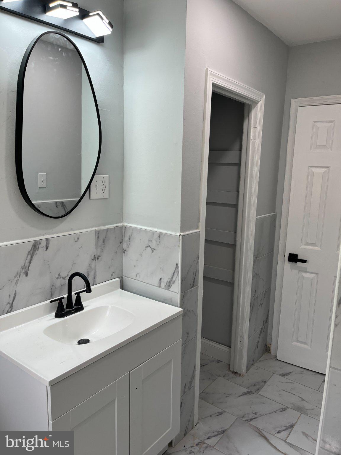 2405 Limestone Road Wilmington, DE 19808 - Photo 25 of 40 a bathroom with a sink and a mirror