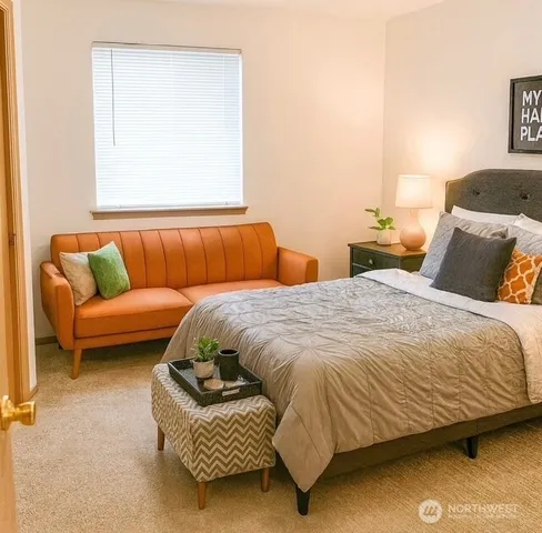 a bedroom with a bed and couch