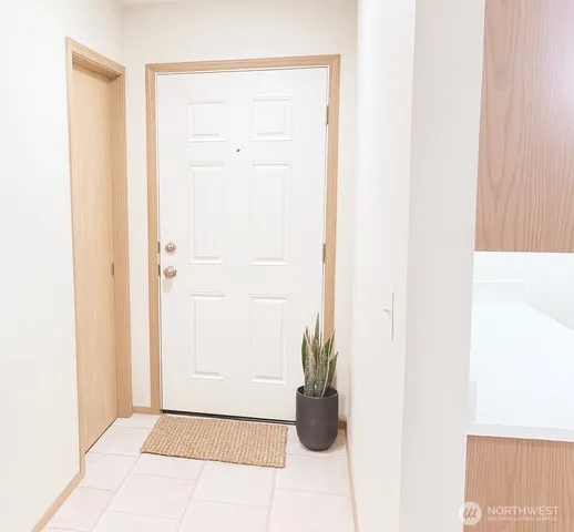 a view of a closet area with wooden floor