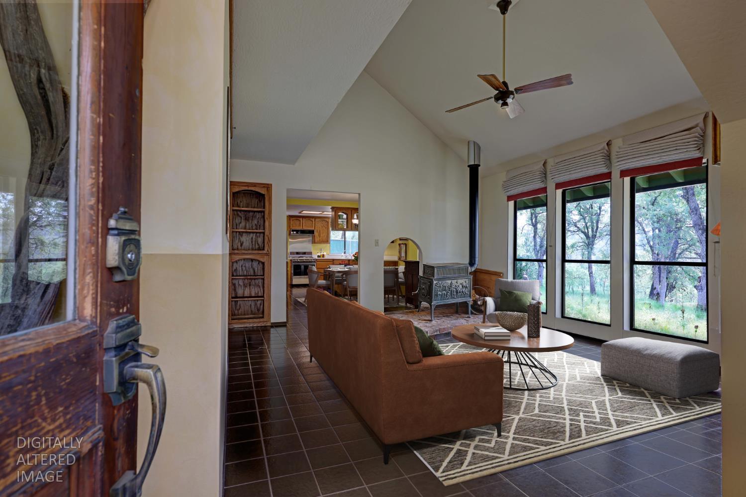 1480 Sage Road Colfax, CA 95713 - Photo 6 of 52 Floor to ceiling windows pull natural light into the living space throughout the day, keeping the home bright and naturally temperature-regulated due to the passive solar design.