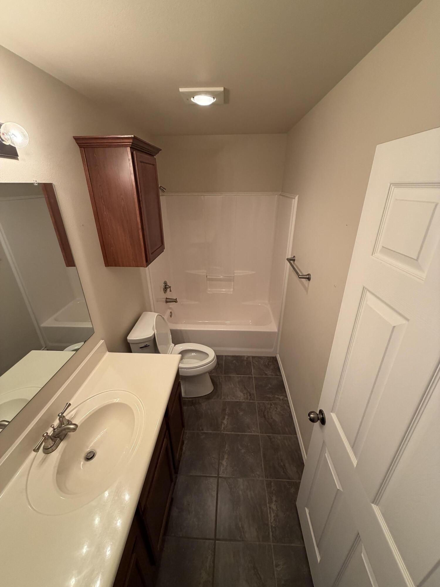 6544 84th Street Lubbock, TX 79424 - Photo 24 of 29 a bathroom with a sink a toilet and shower
