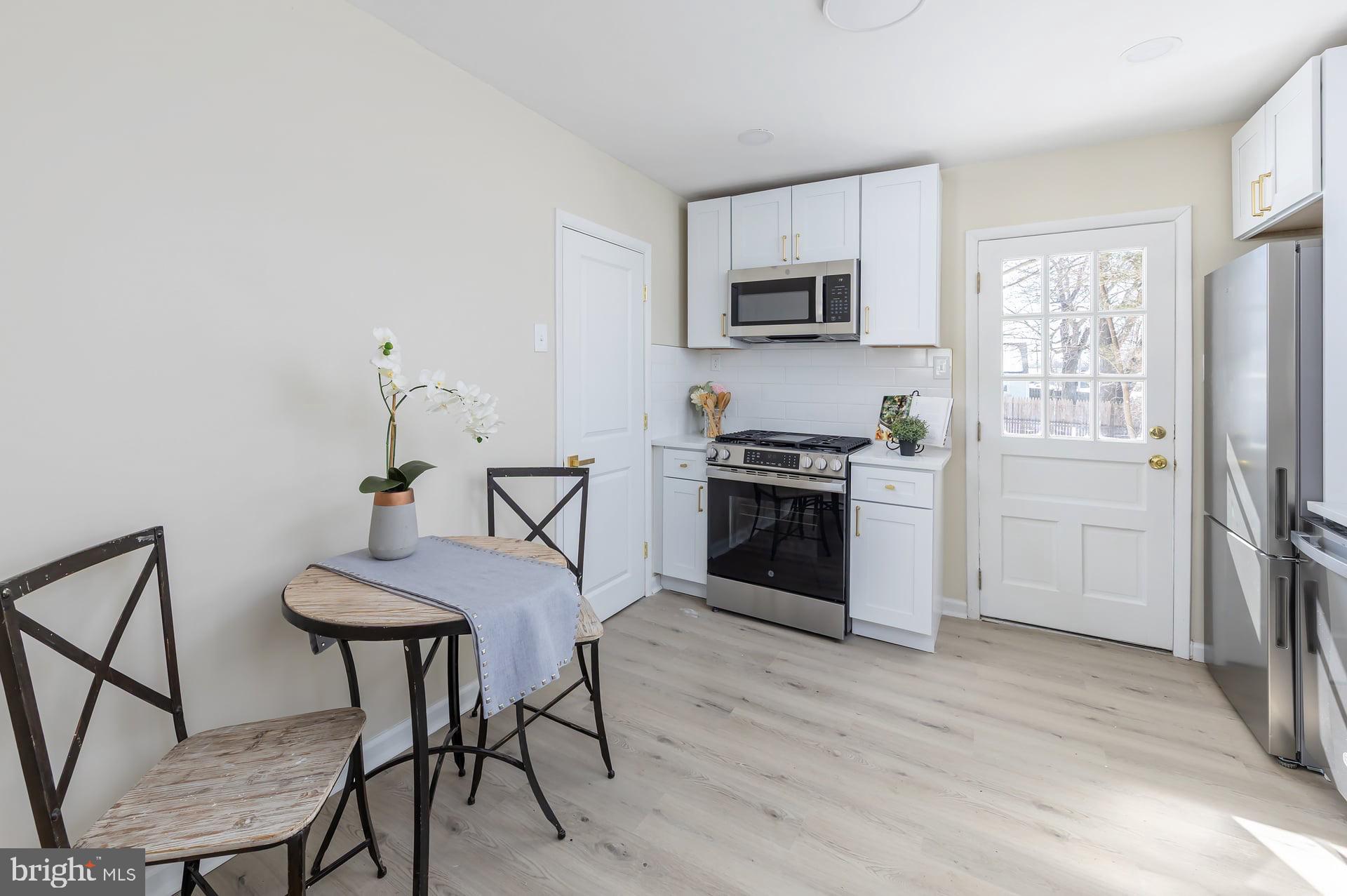 1117 Monmouth Road Deptford, NJ 08096 - Photo 11 of 18 a kitchen with stainless steel appliances a stove a sink cabinets and a refrigerator
