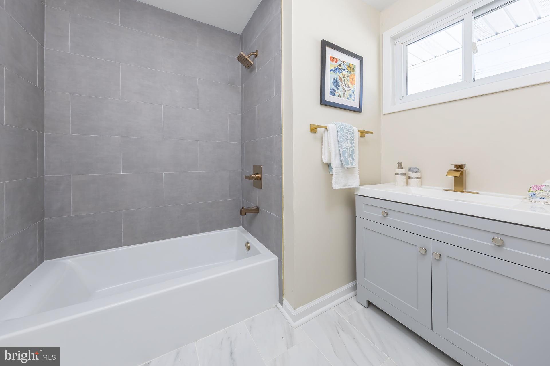1117 Monmouth Road Deptford, NJ 08096 - Photo 13 of 18 a bathroom with a bathtub and a sink