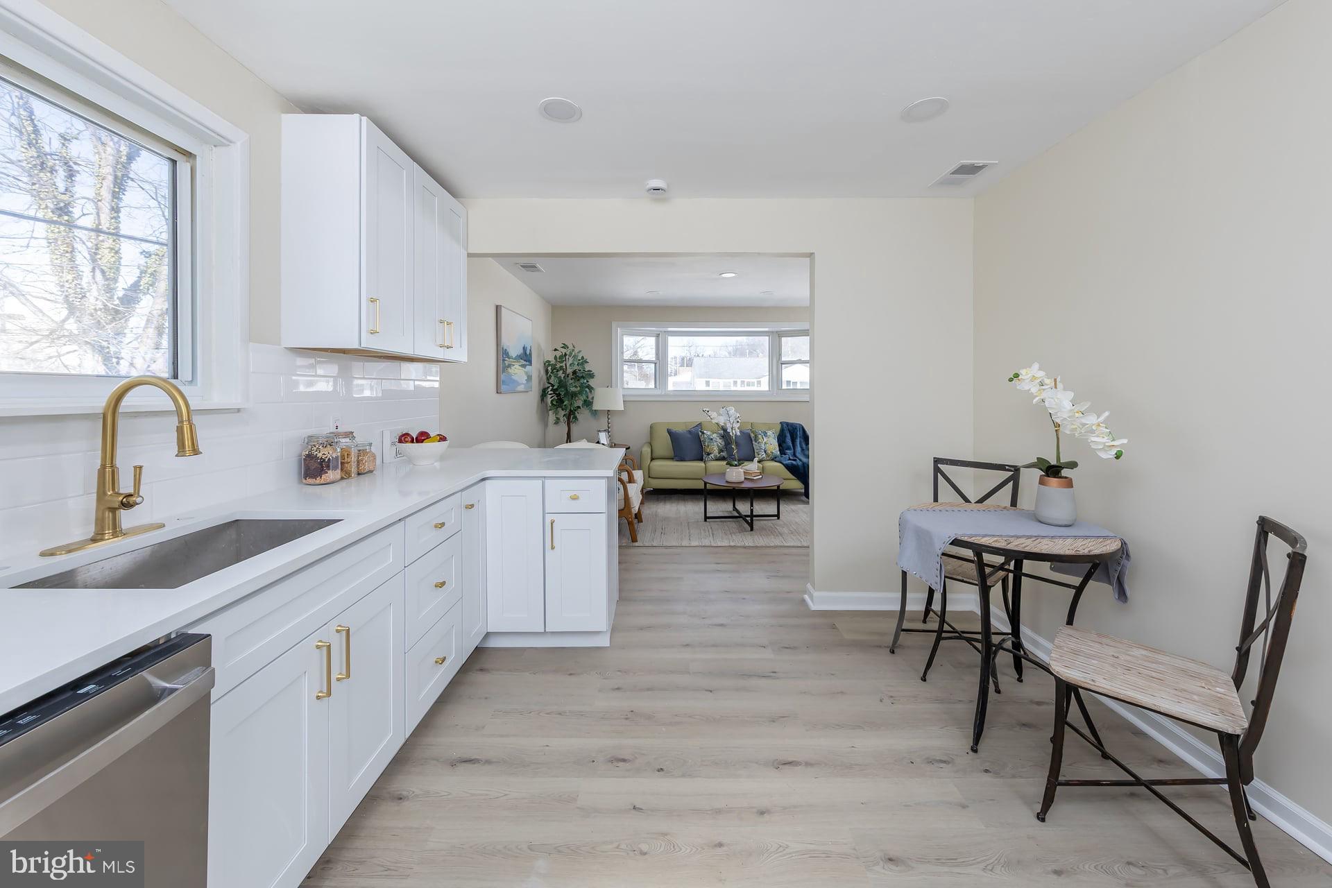 1117 Monmouth Road Deptford, NJ 08096 - Photo 10 of 18 a kitchen with sink cabinets and window