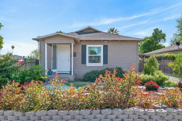a kitchen with a refrigerator and a stove top oven