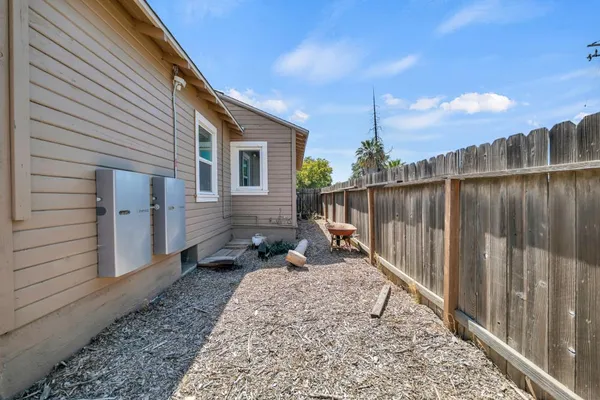 a patio with glass top table and chairs