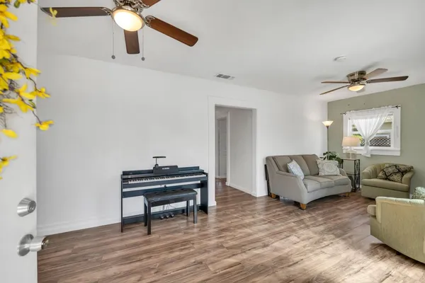 a living room with furniture and a chandelier