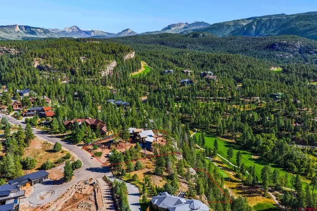 a view of a house with a mountain and a forest