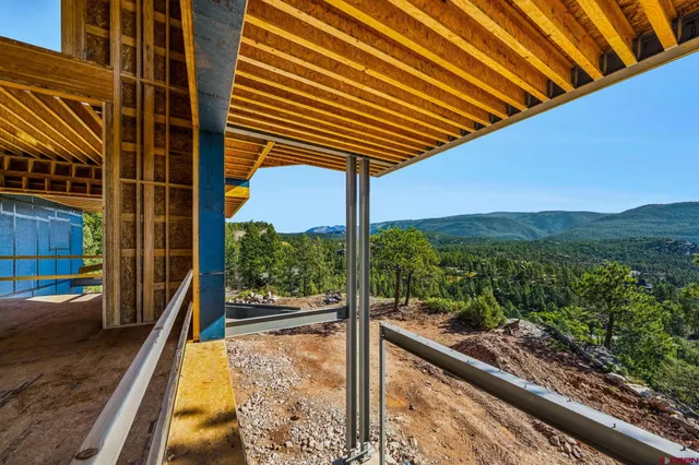 a view of a porch with a floor to ceiling window and wooden fence