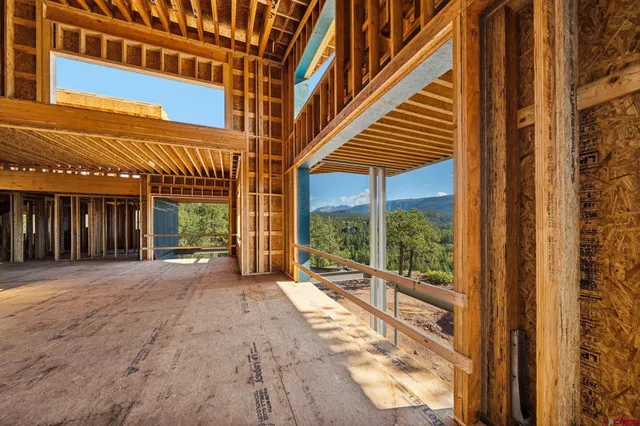 a view of backyard with large window and wooden floor