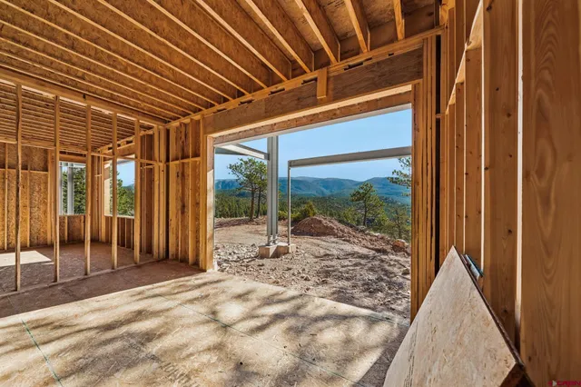 a view of a room with a large window and walk in closet