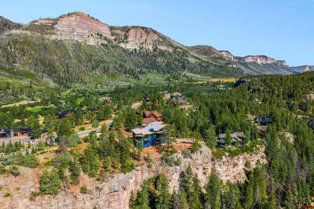 a view of a house with a mountain in the background