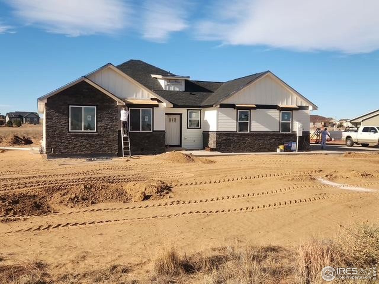 16505 Fairbanks Road North Platteville, CO 80651 - Photo 11 of 13 a front view of a house with a yard covered in snow