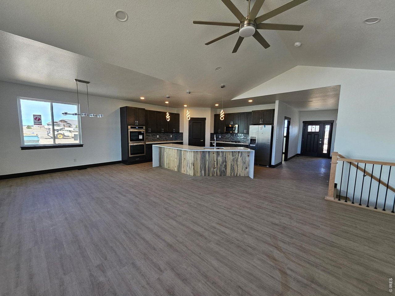 16505 Fairbanks Road North Platteville, CO 80651 - Photo 7 of 13 a view of a big room with wooden floor and windows