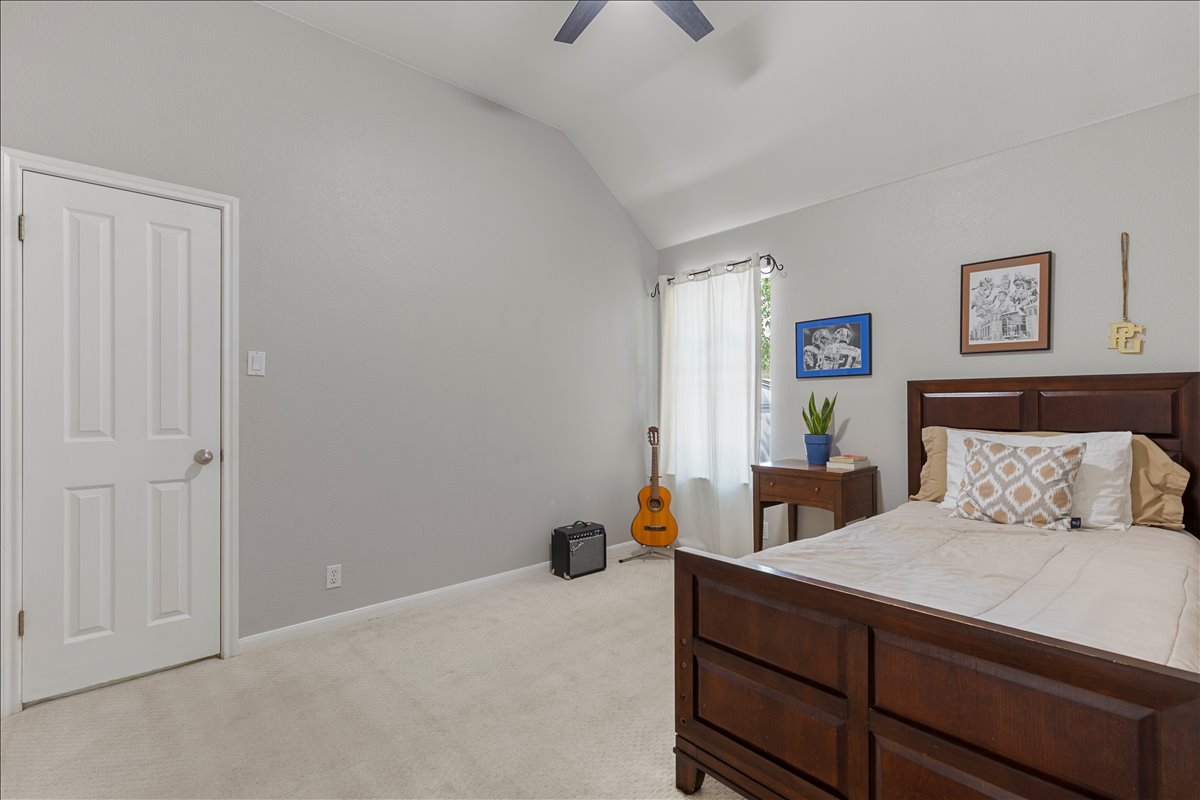 9012 Meacham Way Austin, TX 78749 - Photo 23 of 34 Vaulted ceiling bedroom featuring light-toned carpeting and a white paneled door