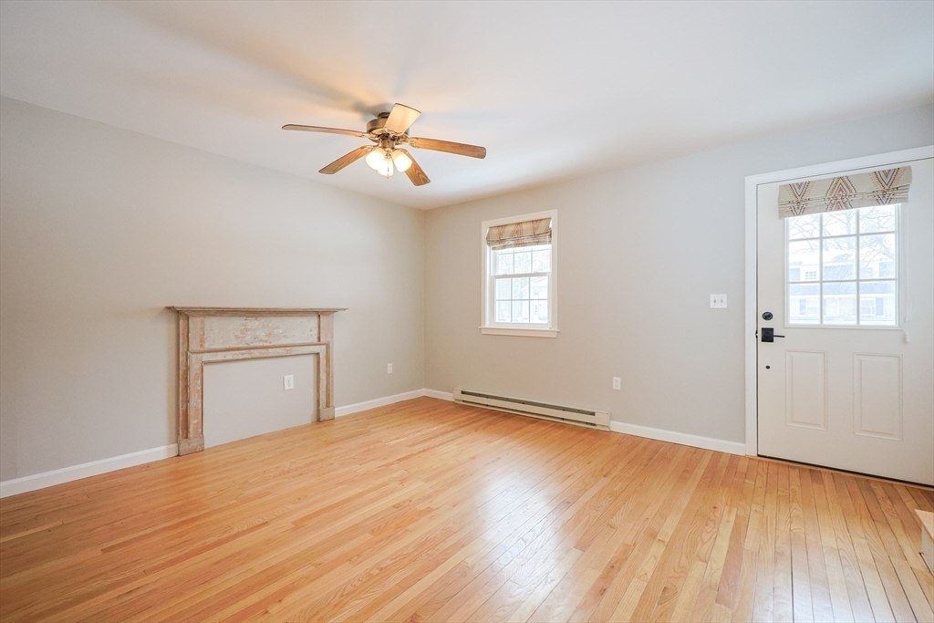 75 Sandy Pond Road, Unit 24 Ayer, MA 01432 - Photo 11 of 41 a view of empty room with wooden floor and fan