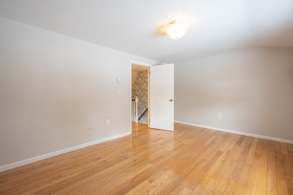 75 Sandy Pond Road, Unit 24 Ayer, MA 01432 - Photo 15 of 41 a view of an empty room with wooden floor and a window