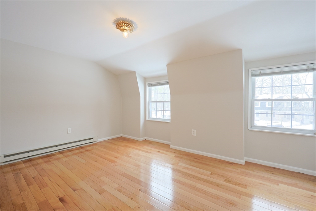 75 Sandy Pond Road, Unit 24 Ayer, MA 01432 - Photo 19 of 41 an empty room with wooden floor and windows