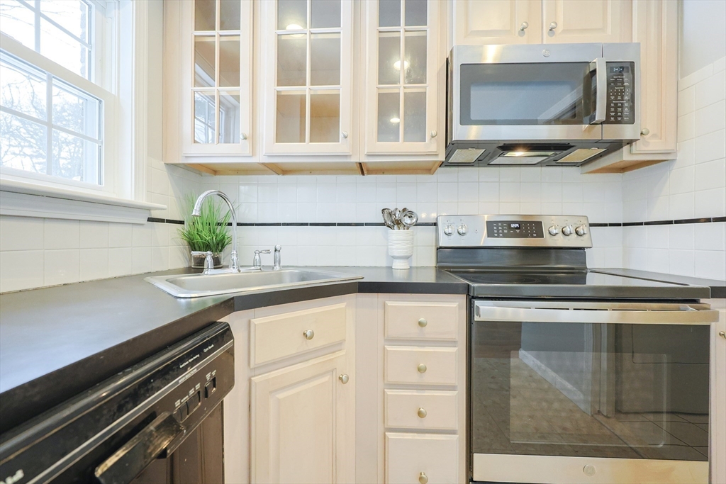 75 Sandy Pond Road, Unit 24 Ayer, MA 01432 - Photo 2 of 41 a kitchen with stainless steel appliances granite countertop a stove a sink and a microwave