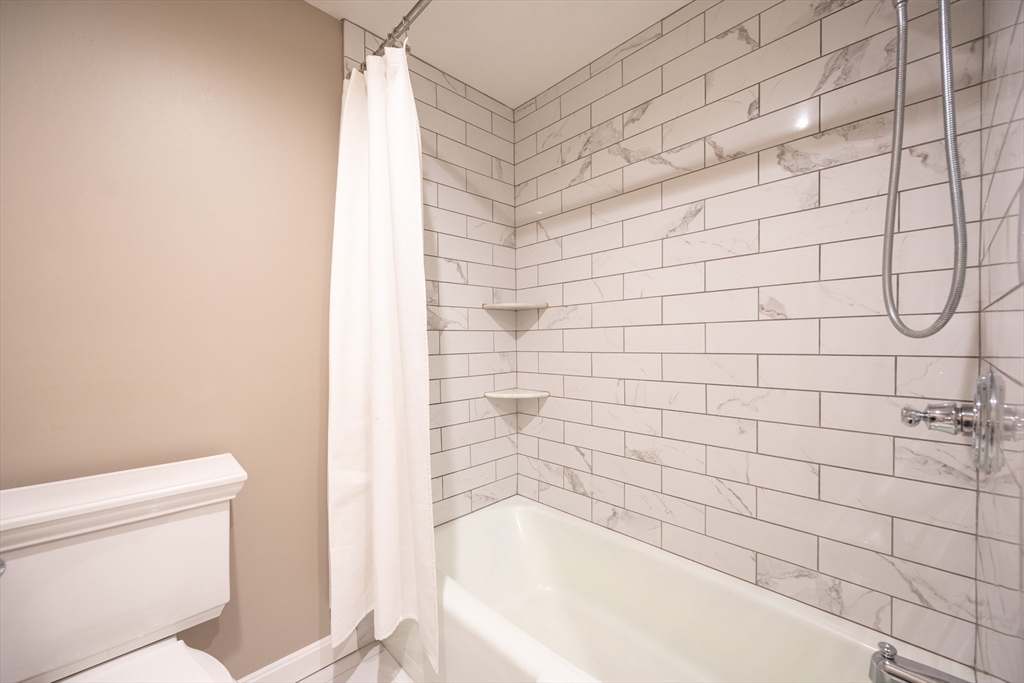 75 Sandy Pond Road, Unit 24 Ayer, MA 01432 - Photo 22 of 41 a bathroom with a bathtub and toilet