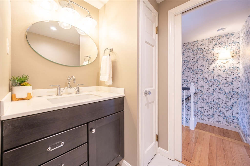 75 Sandy Pond Road, Unit 24 Ayer, MA 01432 - Photo 24 of 41 a bathroom with a sink a mirror a vanity and shower