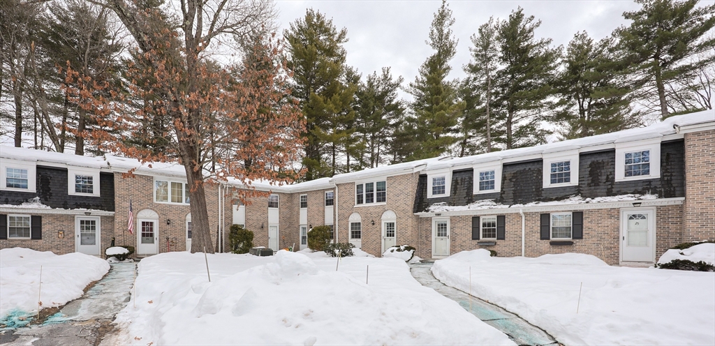 75 Sandy Pond Road, Unit 24 Ayer, MA 01432 - Photo 34 of 41 a front view of a building with a yard