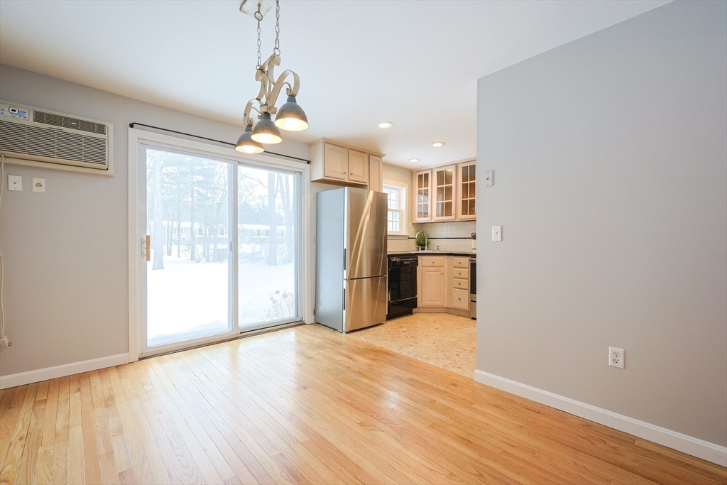 75 Sandy Pond Road, Unit 24 Ayer, MA 01432 - Photo 5 of 41 a view of a kitchen with wooden floor electronic appliances and a window