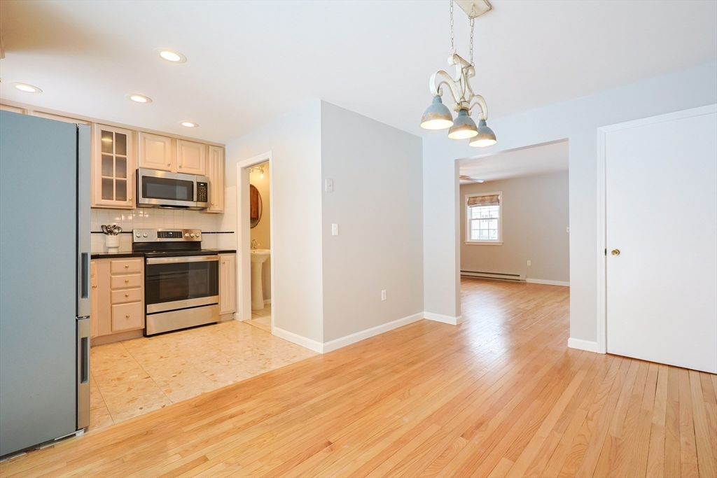75 Sandy Pond Road, Unit 24 Ayer, MA 01432 - Photo 6 of 41 a open kitchen with stainless steel appliances granite countertop a refrigerator and a stove top oven