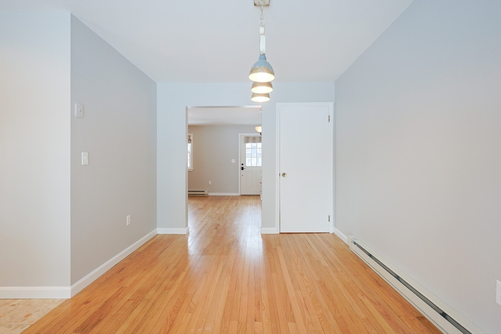 75 Sandy Pond Road, Unit 24 Ayer, MA 01432 - Photo 7 of 41 a view of empty room with wooden floor and fan