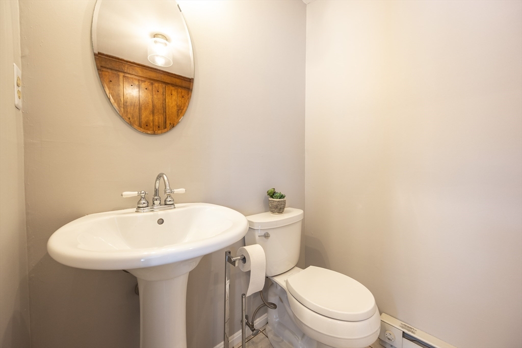 75 Sandy Pond Road, Unit 24 Ayer, MA 01432 - Photo 8 of 41 a bathroom with a toilet a sink and mirror