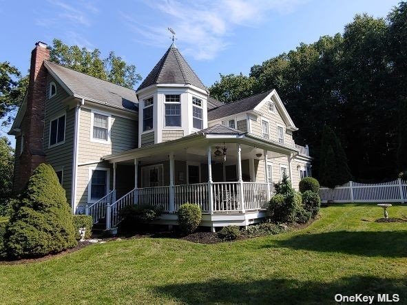 a view of house with yard and green space