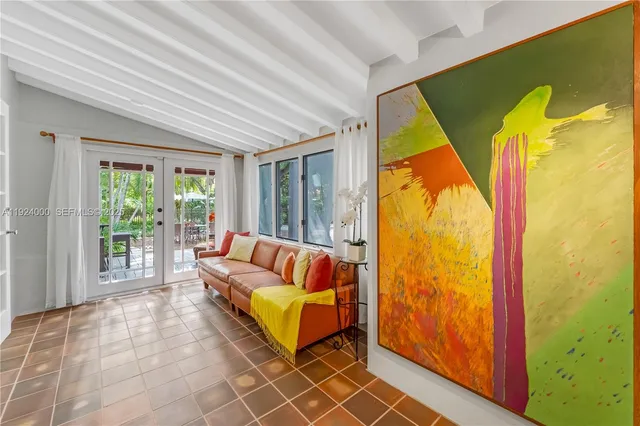 a living room with furniture a ceiling fan and a rug