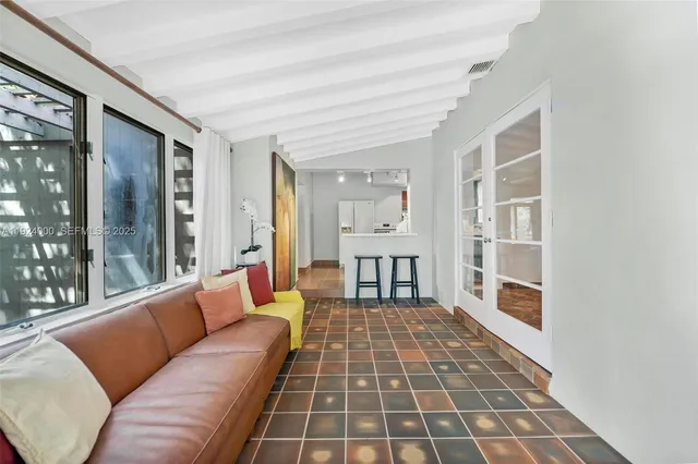 a living room with furniture a couch and a dining table