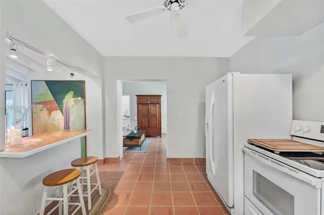 a kitchen with a sink a counter top space cabinets and stainless steel appliances