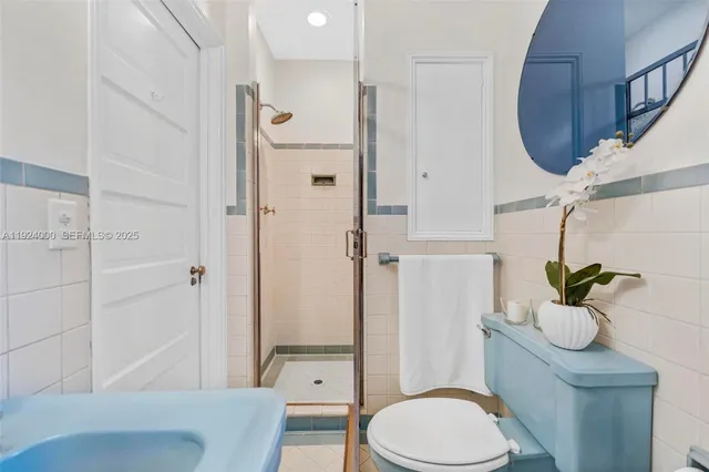 a bathroom with a sink mirror vanity and toilet