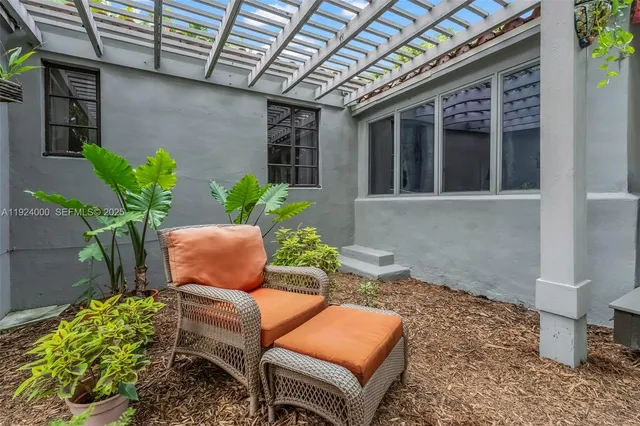 a view of a yard with plants and trees