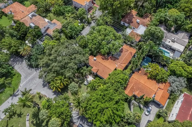 a backyard of a house with garden and outdoor seating