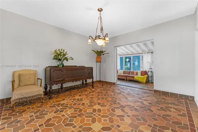 a view of a livingroom with a dinning area furniture and a chandelier