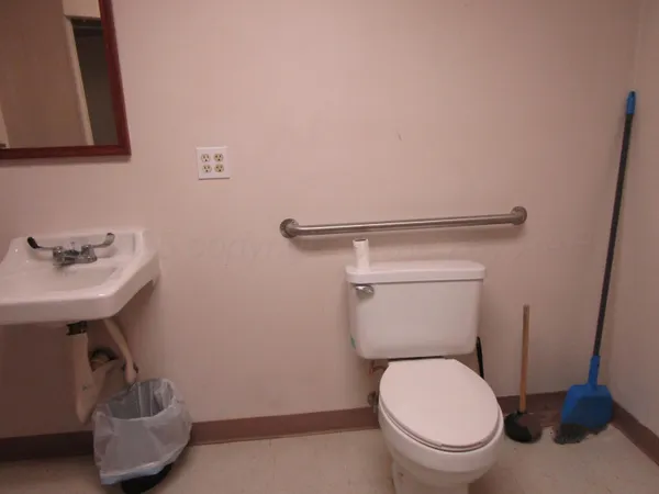 a white toilet sitting next to a bathroom sink