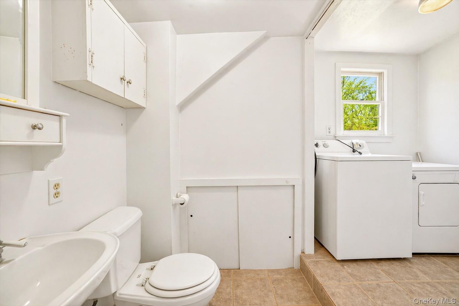 1835 Jacob Road Cortlandt Manor, NY 10567 - Photo 12 of 27 a white toilet sitting next to a bathroom sink